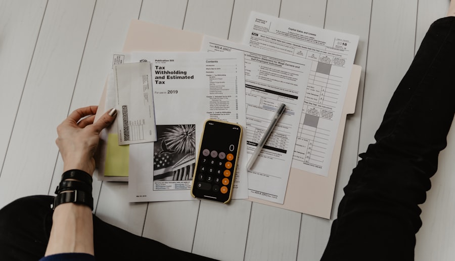 Statements, a calculator and a notebook spread across a kitchen table