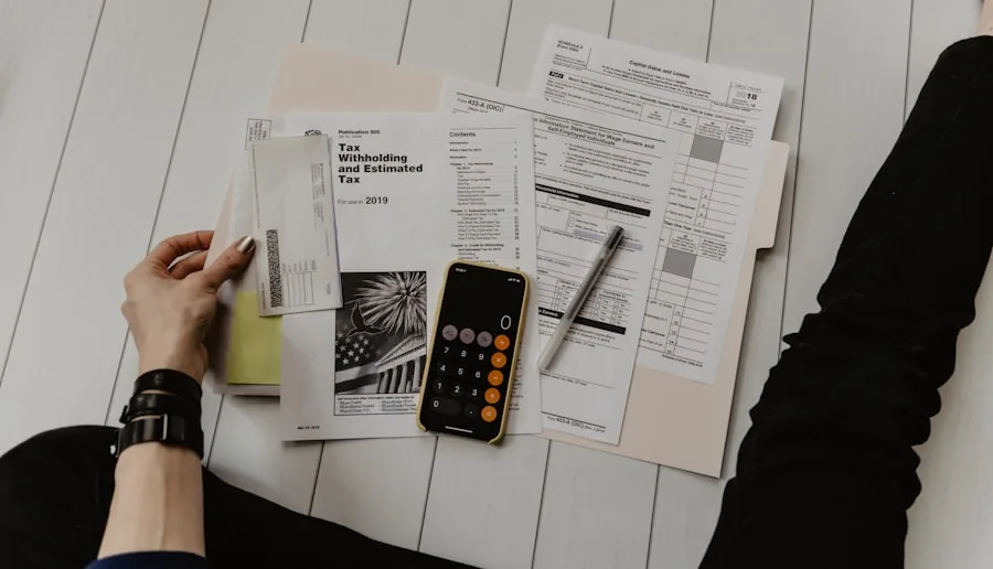 Statements, a calculator and a notebook spread across a kitchen table